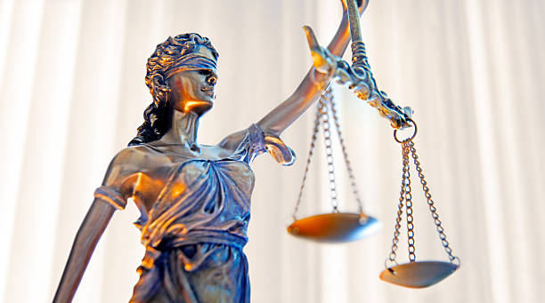 lady justice in front of row of columns